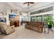 Spacious living room featuring neutral carpet, comfortable seating, and plenty of natural light at 6436 Longlake Dr, Port Orange, FL 32128