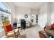 Bright home office features a large window, neutral carpet, and an organized workspace with a desk and chair at 6436 Longlake Dr, Port Orange, FL 32128