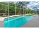 Relaxing pool area with built-in stone water feature, perfect for enjoying sunny days at 6436 Longlake Dr, Port Orange, FL 32128