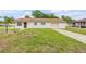 Charming single-story home featuring a well-maintained lawn and an attached one car garage at 701 West St, New Smyrna Beach, FL 32168