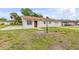 View of the exterior showcasing its cozy front yard and an attached one car garage at 701 West St, New Smyrna Beach, FL 32168