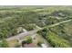 Home nestled in a wooded area with a pond view from above at 703 Volco Rd, Edgewater, FL 32141