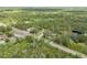 Aerial image displaying the property, wooded landscape, and neighborhood at 703 Volco Rd, Edgewater, FL 32141