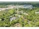 Aerial view highlighting a private home surrounded by lush greenery, near a developing neighborhood at 703 Volco Rd, Edgewater, FL 32141