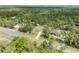 An aerial shot displays the home among the trees and landscape at 703 Volco Rd, Edgewater, FL 32141