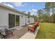 The back patio includes an exterior door, sitting area, and shed for additional storage at 703 Volco Rd, Edgewater, FL 32141