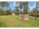 A fully-grassed, well-maintained backyard featuring a storage shed and privacy fencing at 703 Volco Rd, Edgewater, FL 32141