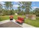 The backyard includes a cozy sitting area, lawn, and fire pit at 703 Volco Rd, Edgewater, FL 32141