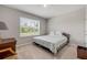 Bedroom with a queen-sized bed, window, and chair at 703 Volco Rd, Edgewater, FL 32141