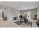 An open-concept dining area with black table, chairs, and a sliding glass door leading to the backyard at 703 Volco Rd, Edgewater, FL 32141