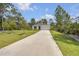 Inviting single-story home with a long driveway and well-manicured lawn at 703 Volco Rd, Edgewater, FL 32141