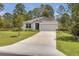Charming single-story home with a long driveway and a two-car garage at 703 Volco Rd, Edgewater, FL 32141
