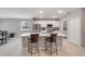 Kitchen featuring white cabinets, tile flooring, stainless steel appliances, and an island with bar stool seating at 703 Volco Rd, Edgewater, FL 32141