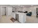 Spacious kitchen featuring a large island with stainless steel dishwasher and an open view into the living room at 703 Volco Rd, Edgewater, FL 32141