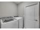 Functional laundry room with modern appliances, washer, dryer, and storage at 703 Volco Rd, Edgewater, FL 32141