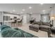 Open-concept living room with tile flooring, a gray sofa and a breakfast bar that connects to the kitchen at 703 Volco Rd, Edgewater, FL 32141