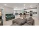 Bright open floor plan featuring tile floors, a kitchen with white cabinets, and a comfy living area at 703 Volco Rd, Edgewater, FL 32141