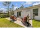 Outdoor patio with comfortable seating, a table, and a peaceful view of the yard at 703 Volco Rd, Edgewater, FL 32141