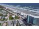 Stunning aerial view of beachfront homes and condos along the scenic coastline with blue ocean water at 705 N Atlantic Ave # 4030, New Smyrna Beach, FL 32169