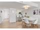 Bright dining room area with a marble table and modern chairs near the kitchen bar at 705 N Atlantic Ave # 4030, New Smyrna Beach, FL 32169
