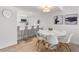 Bright dining room area with a marble table and modern chairs near the kitchen bar at 705 N Atlantic Ave # 4030, New Smyrna Beach, FL 32169