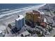 A beachfront condo complex provides easy access to the beach and ocean, alongside a parking lot and swimming pool at 705 N Atlantic Ave # 4030, New Smyrna Beach, FL 32169
