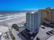A beachfront condo complex provides easy access to the beach and ocean, alongside a parking lot and swimming pool at 705 N Atlantic Ave # 4030, New Smyrna Beach, FL 32169