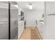 Bright kitchen with white cabinets and countertops, stainless steel appliances, and wood floors at 705 N Atlantic Ave # 4030, New Smyrna Beach, FL 32169