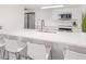 Bright kitchen with white cabinets and countertops, stainless steel appliances, and wood floors at 705 N Atlantic Ave # 4030, New Smyrna Beach, FL 32169