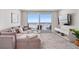 Coastal living room features ocean views, comfortable seating, and a modern entertainment center at 705 N Atlantic Ave # 4030, New Smyrna Beach, FL 32169
