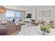 Bright living room featuring a large sectional sofa and sliding glass doors with ocean views at 705 N Atlantic Ave # 4030, New Smyrna Beach, FL 32169