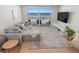 Living room featuring ocean views, comfortable seating, and a modern entertainment center at 705 N Atlantic Ave # 4030, New Smyrna Beach, FL 32169