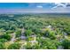 A beautiful high-angle view showing a house surrounded by mature trees and neighborhood at 795 Sugar Cane Ln, Port Orange, FL 32129