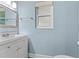 Powder room featuring a sleek vanity, contemporary mirror, and light blue wall at 795 Sugar Cane Ln, Port Orange, FL 32129