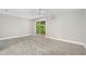 Spacious bedroom with a ceiling fan and sliding glass door leading to the outside at 795 Sugar Cane Ln, Port Orange, FL 32129