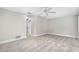 Neutral bedroom features carpeting and a ceiling fan, with a glimpse into the hallway at 795 Sugar Cane Ln, Port Orange, FL 32129