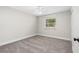 Inviting bedroom featuring carpeting, neutral walls and a sunlit window at 795 Sugar Cane Ln, Port Orange, FL 32129