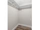 Walk-in closet with laminate flooring and shelf and rod system for storage at 795 Sugar Cane Ln, Port Orange, FL 32129
