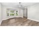 Dining area features wood-look flooring and a large window with a view of the front yard at 795 Sugar Cane Ln, Port Orange, FL 32129