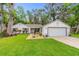 Charming single-story home with attached garage and manicured front yard at 795 Sugar Cane Ln, Port Orange, FL 32129