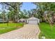 Single-story home featuring a brick driveway, attached garage and well-maintained lawn at 795 Sugar Cane Ln, Port Orange, FL 32129