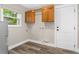 Spacious laundry area with wooden cabinets, hanging rod, and modern vinyl flooring at 795 Sugar Cane Ln, Port Orange, FL 32129