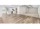 Open-concept living area with stylish flooring, leading to a modern kitchen and bright spaces at 795 Sugar Cane Ln, Port Orange, FL 32129