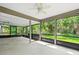Large screened lanai surrounded by lush, mature trees at 795 Sugar Cane Ln, Port Orange, FL 32129