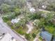 Aerial view of the home on a large lot featuring the home, garage, driveway, and mature tree canopy at 801 Canal St, New Smyrna Beach, FL 32168