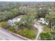 Aerial view of property with mature trees showing the home, garage, storage building and lot boundaries at 801 Canal St, New Smyrna Beach, FL 32168