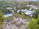 Aerial view of the home on a large lot featuring the home, garage, driveway, and mature tree canopy at 801 Canal St, New Smyrna Beach, FL 32168