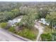 Aerial view of property with mature trees showing the home, garage, storage building and lot boundaries at 801 Canal St, New Smyrna Beach, FL 32168
