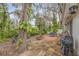 Brick paved back patio with outdoor dining set, grill, and natural landscaping at 801 Canal St, New Smyrna Beach, FL 32168