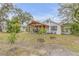 Charming backyard with covered patio and lush greenery, perfect for outdoor entertaining at 801 Canal St, New Smyrna Beach, FL 32168